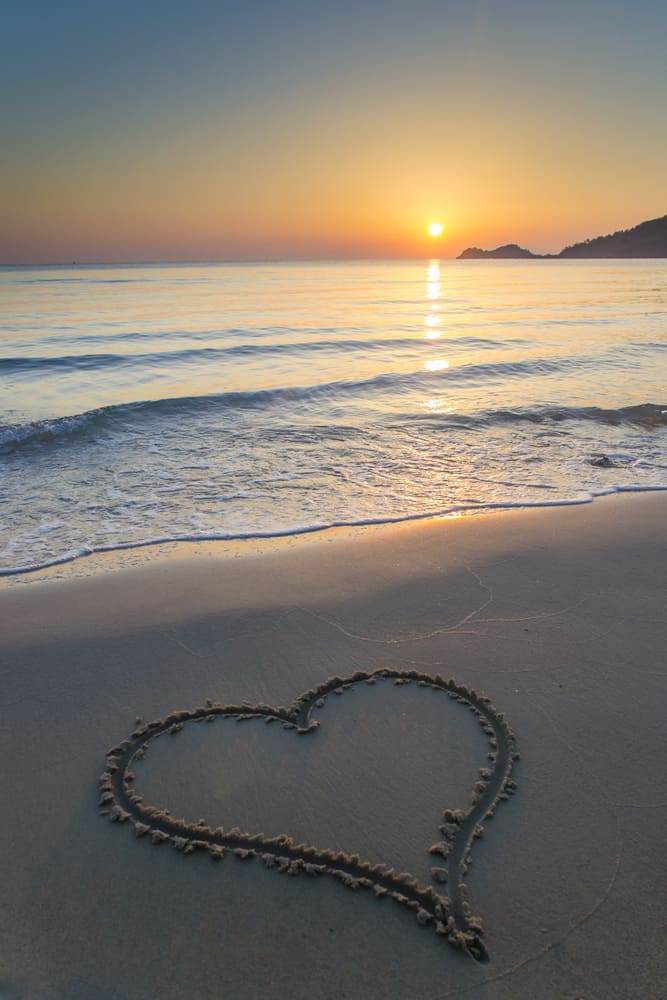 Heart shape drawn on a  sandy beach at sunrise on the beautiful island of Thassos, Greece.