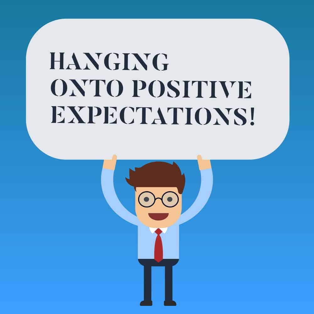 Writing note showing Hanging Onto Positive Expectations. Business photo showcasing Motivation optimism expecting the best Man Standing Holding Above his Head Blank Rectangular Colored Board