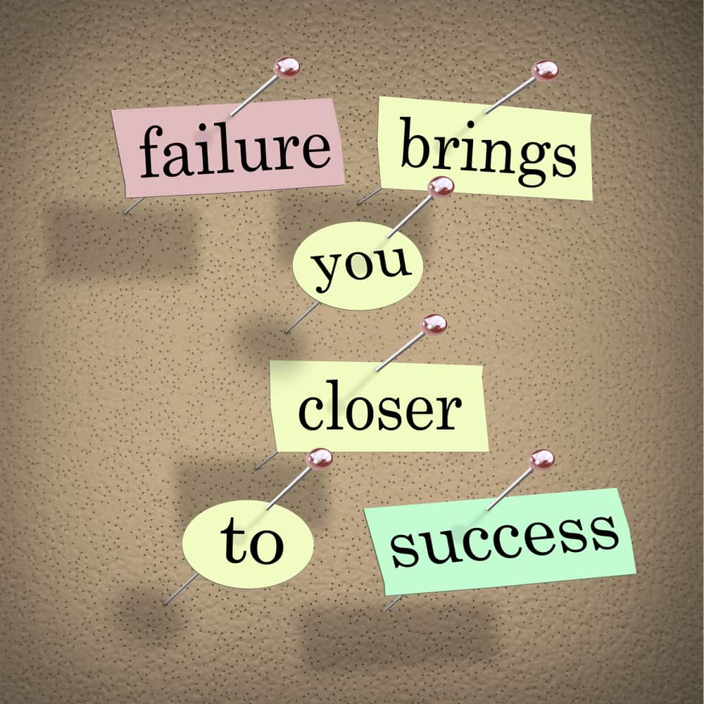 The words Failure Brings You Closer to Success on pieces of paper pinned to a bulletin board, encouraing you to see a challenge as an opportunity that is a step to succeed in a goal
