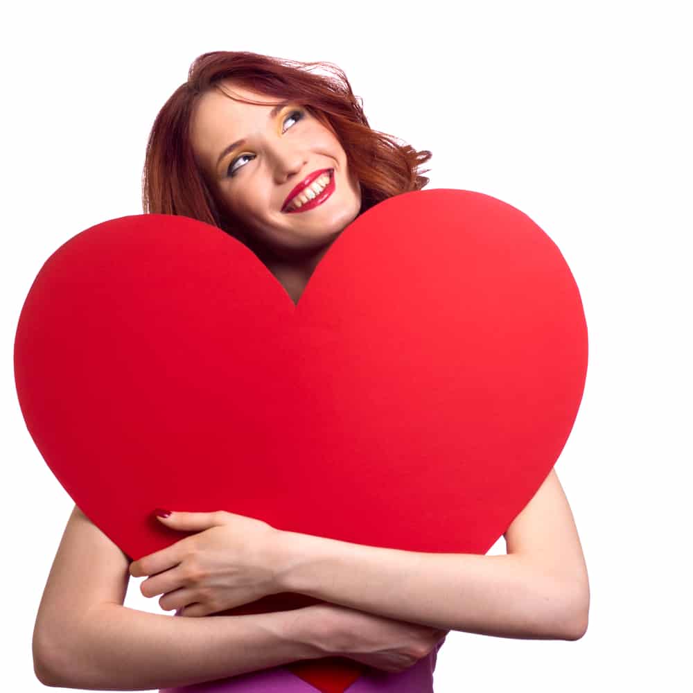 Valentines Day. Woman holding Valentines Day heart sign with copy space
